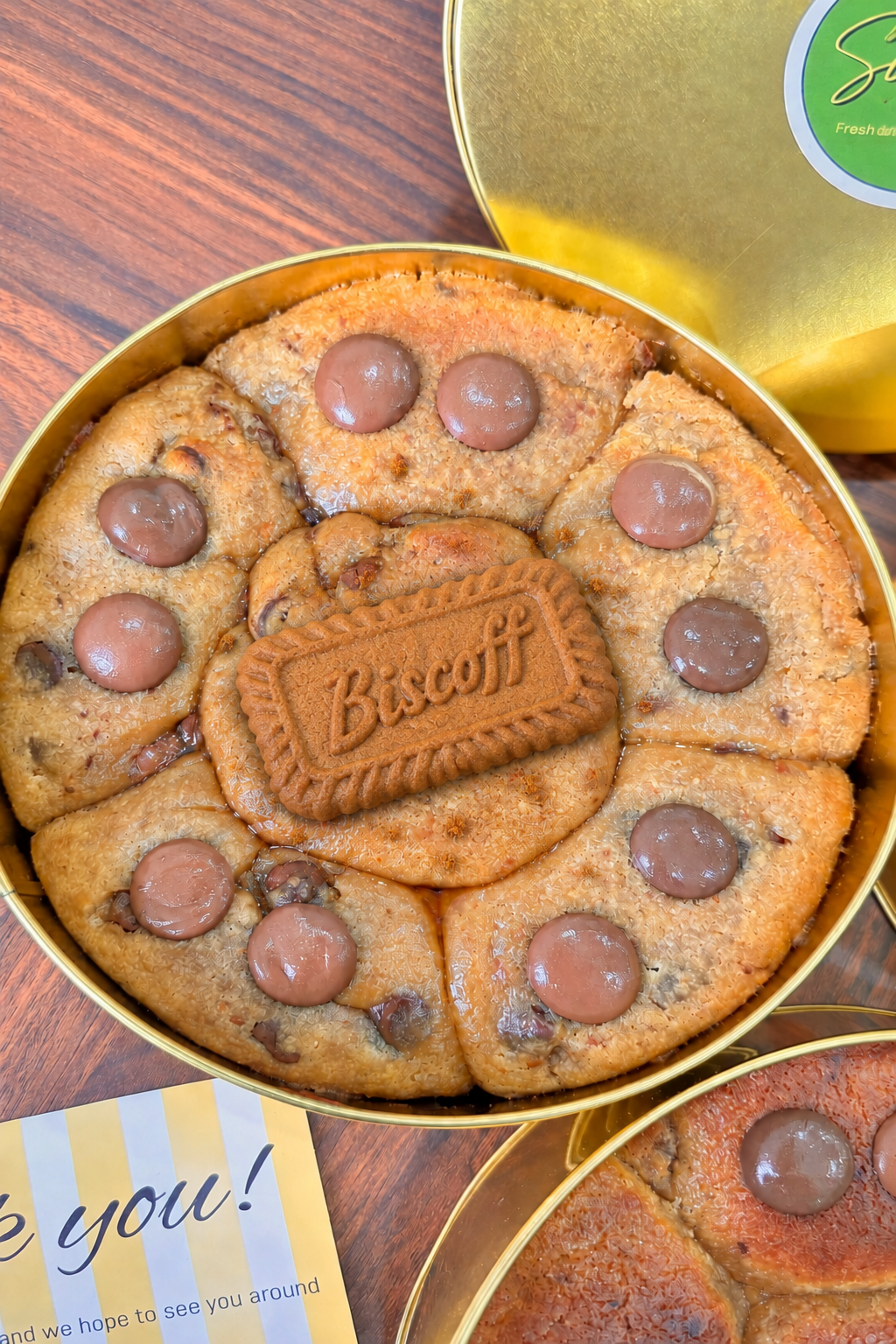 Cookie tin with a Biscoff-labeled biscuit and crumbs